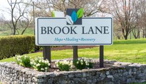 Front entrance sign of Brook Lane's main campus